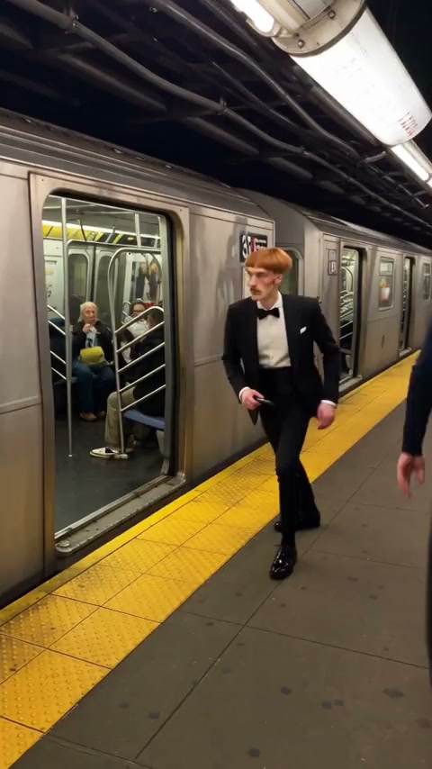 Tuxedo-clad lead in the Phone Stuck to Train AI community example